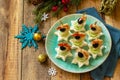 Festive snack of canapes on the Christmas table. Canapes with cheese, cucumber and shrimps. Copy space