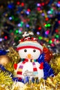 Festive snowman with Christmas balls, tinsel on blurred lights background Royalty Free Stock Photo