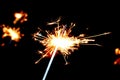 Festive sparklers on a black background. People lit the sparklers under the chiming clock for the new year Royalty Free Stock Photo