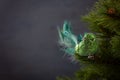 Festive sparkling green bird on the Christmas tree