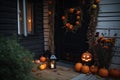 In the festive spirit of Halloween, spooky pumpkins decorate the front door of a beautiful home, creating an elegant and modest