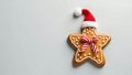 festive star cookie wearing a christmas hat, isolated against a plain background - generated using ai Royalty Free Stock Photo