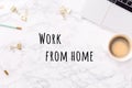 Festive stationary with laptop and coffee on white marble background with Work from home wording. Feminine job, gender