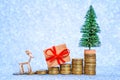 Festive Steps: Coin Stacks with Toy Tree and Deer Royalty Free Stock Photo