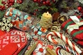 Festive still life with burning candle, jar of candy, knitted mittens and lollypop