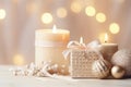 Festive still life with gift box, burning candles and Christmas decorations on bokeh background. Christmas composition for home