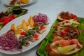 Festive table with appetizers. Cheese plate with honey and nuts. Herring with onions, quail eggs with red caviar. Bread with meat Royalty Free Stock Photo