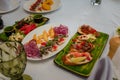 Festive table with appetizers. Cheese plate with honey and nuts. Herring with onions, quail eggs with red caviar. Bread with meat Royalty Free Stock Photo