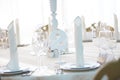 Festive table in the banquet hall are decorated with plates