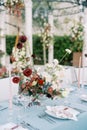 Festive table with colorful bouquets and candles in candlesticks