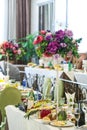 Festive table decor in the restaurant, dishes and flowers