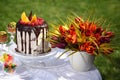 A festive table decorated with birthday cake with flowers and sweets. Royalty Free Stock Photo