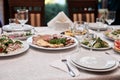 Festive table with delicious appetizers and snacks. Holiday banquet serving with fancy glasses and silverware in restaurant. Royalty Free Stock Photo