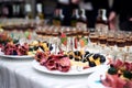 Festive table with delicious appetizers and snacks. Holiday banquet serving with fancy glasses and silverware in restaurant. Royalty Free Stock Photo