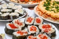 On the festive table are homemade sushi with red caviar, Japanese food Royalty Free Stock Photo