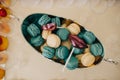 Colorful macarons on pyramid-shaped plastic tower stand as part of candy bar sweet table Royalty Free Stock Photo