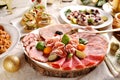 Festive table with a platter of sliced ham and cured meats herrings and sauerkraut stew for Christmas Royalty Free Stock Photo