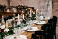 Festive table served for wedding or birthday. Beautiful cutlery, candles, luxurious chairs and table. Elegant dinner table. Party Royalty Free Stock Photo