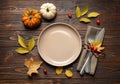 Festive table setting with autumn leaves and pumpkins on wooden background, flat lay. Thanksgiving Day celebration Royalty Free Stock Photo