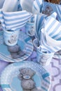 Festive table setting for children. Decoration for children`s party. Teddy bear style serving. Cups, plates and napkins are