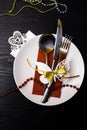 Festive table setting for christmas or new year dinner: vintage fork, spoon,knife on red napkin and christmas decorations on woode Royalty Free Stock Photo