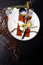 Festive table setting for christmas or new year dinner: vintage fork, spoon,knife on red napkin and christmas decorations on black Royalty Free Stock Photo