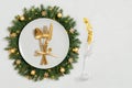 Festive table setting with Christmas wreath and golden decorations on white background with copy space. Happy new year. Space for Royalty Free Stock Photo