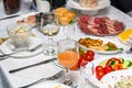 Festive table setting with crystal glasses and plates. Snacks and sandwiches on the table