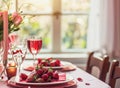 Festive table setting with cutlery, candles and beautiful red flowers in vase Royalty Free Stock Photo