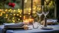 Festive table setting with cutlery, candles and beautiful red flowers in vase