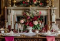 Festive table setting  with cutlery, candles and beautiful red flowers in vase Royalty Free Stock Photo