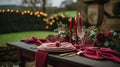 Festive table setting with cutlery, candles and beautiful red flowers in vase Royalty Free Stock Photo