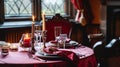 Festive table setting with cutlery, candles and beautiful red flowers in vase Royalty Free Stock Photo