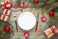 Festive table setting with cutlery and Christmas decorations on