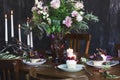 The festive table setting with flowers bouquet, candles and dessert Royalty Free Stock Photo