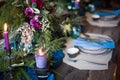 The festive table setting with flowers bouquet, candles and dessert Royalty Free Stock Photo