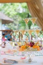 Festive table setting with fruit and wineglasses with champagne. Wedding decor