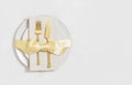Festive table setting with gold cutlery in a plate with bow. Christmas serving on white background with copy space. Top view, flat Royalty Free Stock Photo