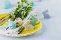 Festive table setting for holiday Easter dinner on light concrete table. Spring Holiday Card Concept Royalty Free Stock Photo