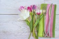 Festive table setting with original cutlery and bouquet of tulips