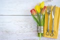 Festive table setting with original cutlery on yellow napkin