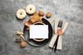 Festive table setting with pumpkins and autumn leaves on grey background, flat lay. Thanksgiving Day celebration Royalty Free Stock Photo