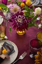 Festive table setting for Thanksgiving day. Autumnal decorations,plates, multicolor glasses and beautiful garden flowers Royalty Free Stock Photo