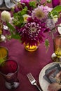 Festive table setting for Thanksgiving day. Autumnal decorations,plates, multicolor glasses and beautiful garden flowers Royalty Free Stock Photo