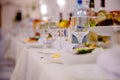 Festive tableware with glasses on a table. Empty glasses stand near plates and forks on banquet table decorated with white Royalty Free Stock Photo