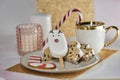 Festive tea cup, Christmas stollen, marshmallow deer, caramel stick, pink candle and cookies. Home aesthetic, cozy tea