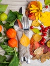 festive thanksgiving autumn cutlery setting and arrangement of colorful fall leaves, red berries Royalty Free Stock Photo