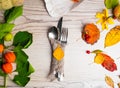 festive thanksgiving autumn cutlery setting and arrangement of colorful fall leaves, red berries, pumpkin Royalty Free Stock Photo