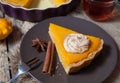 Festive Thanksgiving Homemade Pumpkin Pie with Whipped Cream on rustic background