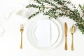 Festive wedding, birthday table setting with golden cutlery, eucalyptus parvifolia branch, porcelain plate, milk and